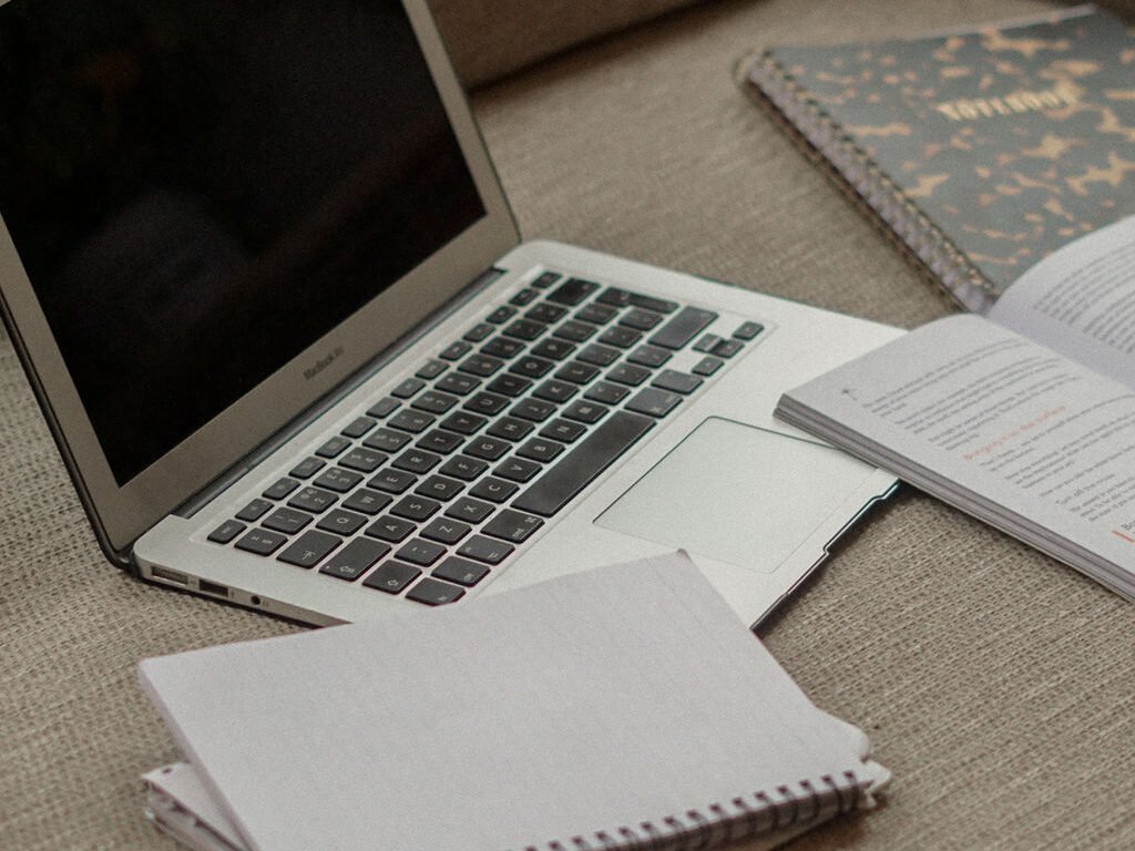 Laptop and notepad on desk